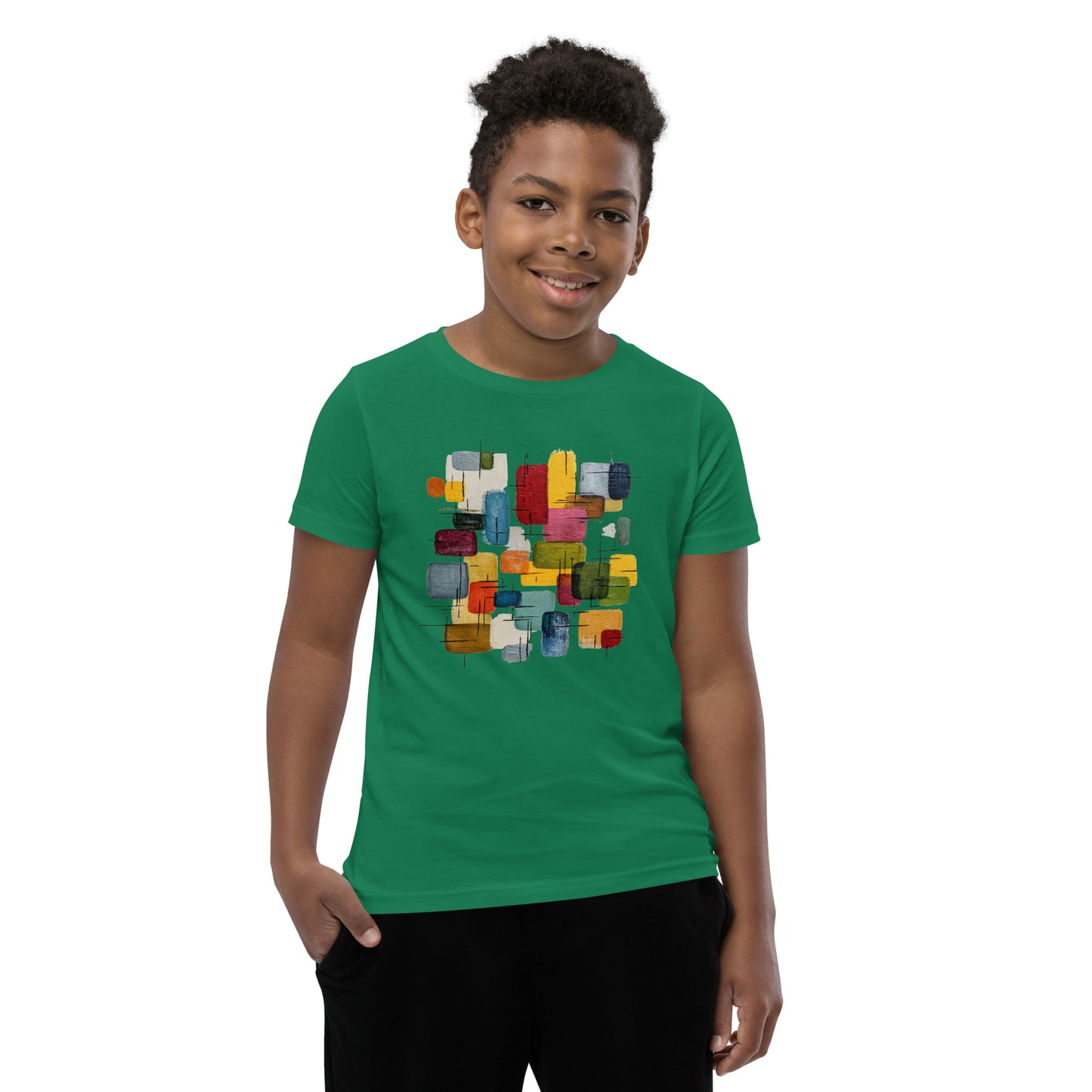 Product mockup. A young man wearing a green, short-sleeve t-shirt with a large, colorful abstract design on the front. The design features overlapping rounded rectangles in red, yellow, teal, blue, green, and orange, with fine black sketch lines, creating a playful and modern look. She is also wearing black leggings.