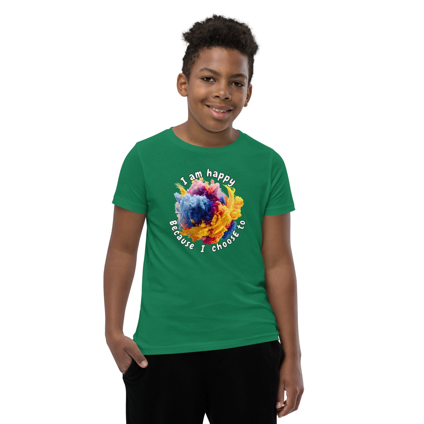 Product mockup. A smiling young boy wearing a green t-shirt with a colorful, cloud-like burst of blue, pink, purple, and yellow at the chest. Above and below the design, curved white text reads, 'I am happy Because I choose to,' in a playful, rounded font.