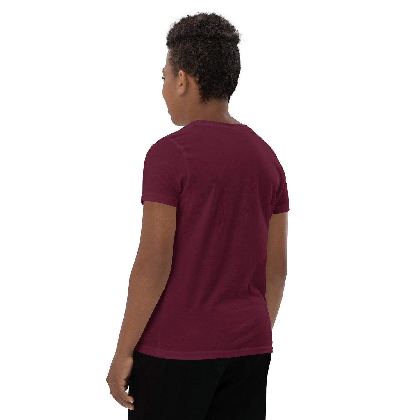 Product mockup. A boy shown from behind wearing a plain maroon, short-sleeve t-shirt and black pants. His curly hair is closely cropped, and the back of the shirt is blank with no visible design or graphics.
