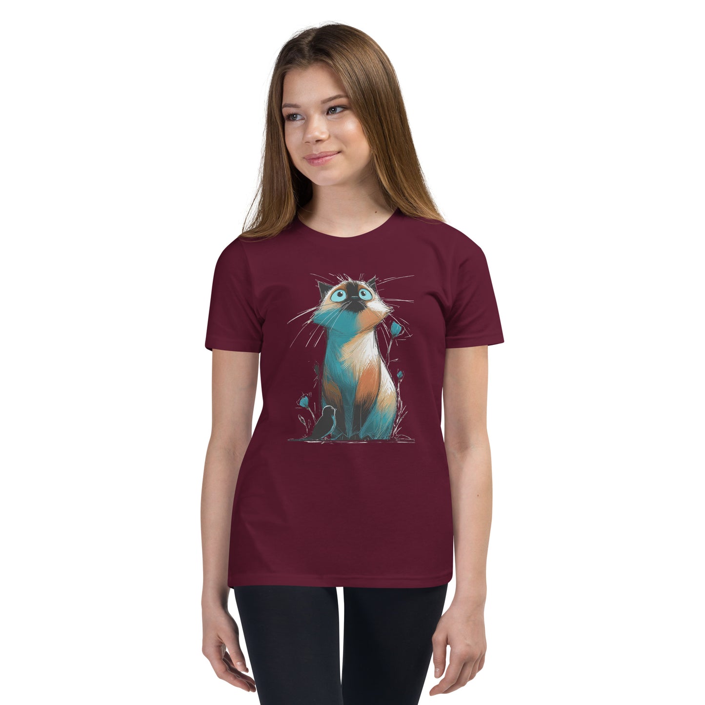 Product mockup. Ultra-soft premium youth maroon t-shirt featuring colorful artistic drawing of a wide-eyed cat sitting beside flowers and a black bird, modeled on young girl.