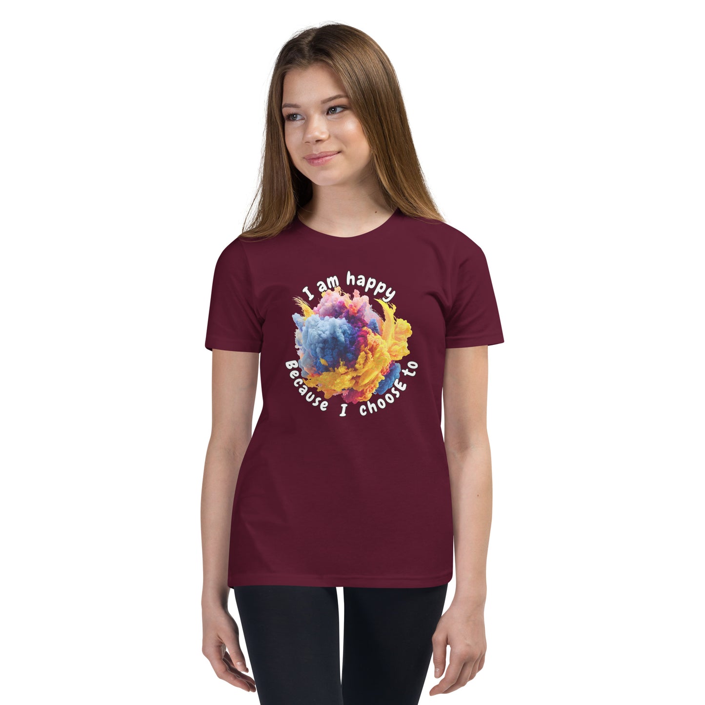 Product mockup. Ultra-soft premium maroon t-shirt featuring vibrant multicolor abstract explosion graphic with text 'I am happy Because I choose to' printed in curved style around the design, modeled on young woman.