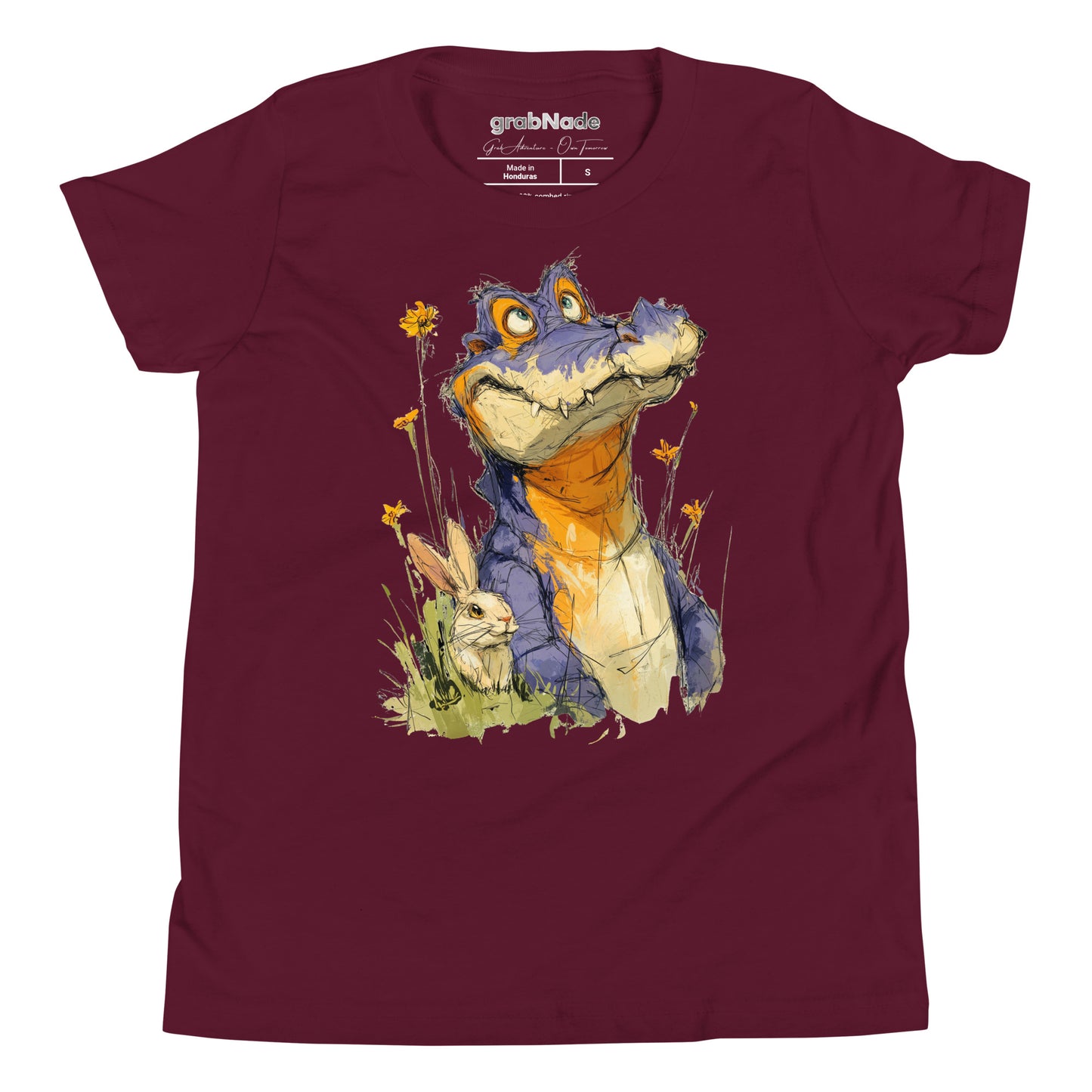 Product mockup. A playful, sketch-style illustration of a cheerful purple alligator with bright orange accents sitting in tall grass and wildflowers, accompanied by a white rabbit nestled by its side. Both characters feature expressive faces and are set against a plain maroon t-shirt background, creating a whimsical and friendly scene.