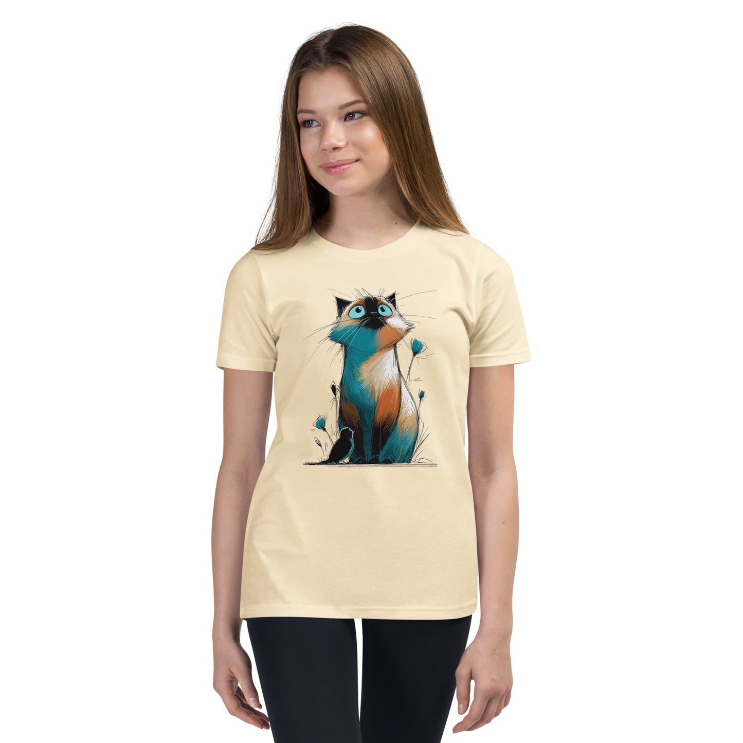 Product mockup. Ultra-soft premium youth natural t-shirt featuring colorful artistic drawing of a wide-eyed cat sitting beside flowers and a black bird, modeled on young girl.
