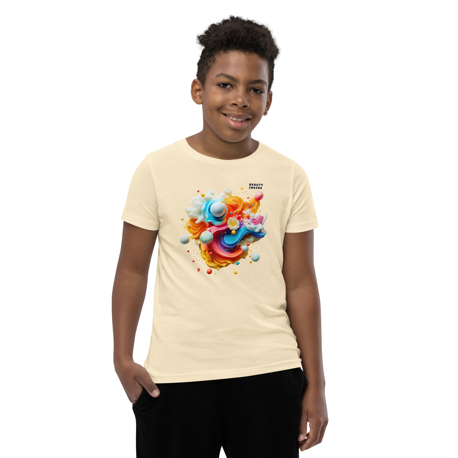 Product mockup. A young boy in a vibrant beige t-shirt featuring a dynamic abstract design at the chest with swirling strokes of yellow, orange, pink, and blue, accented by playful 3D spheres, clouds, and flowers. Near the upper right area of the design, small white block text reads, 'BEAUTY INSIDE