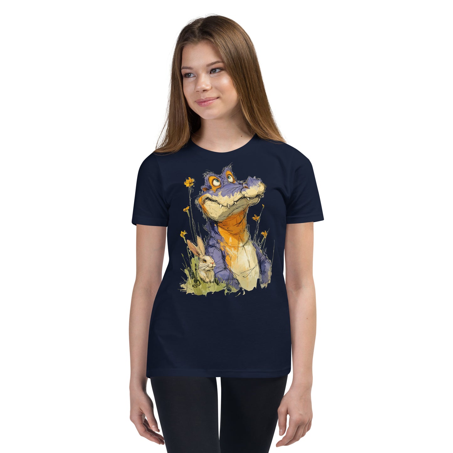 Product mockup. Ultra-soft premium youth navy blue t-shirt featuring whimsical colorful illustration of a playful purple and orange alligator sitting in grass next to a small rabbit and yellow wildflowers, modeled on young girl.