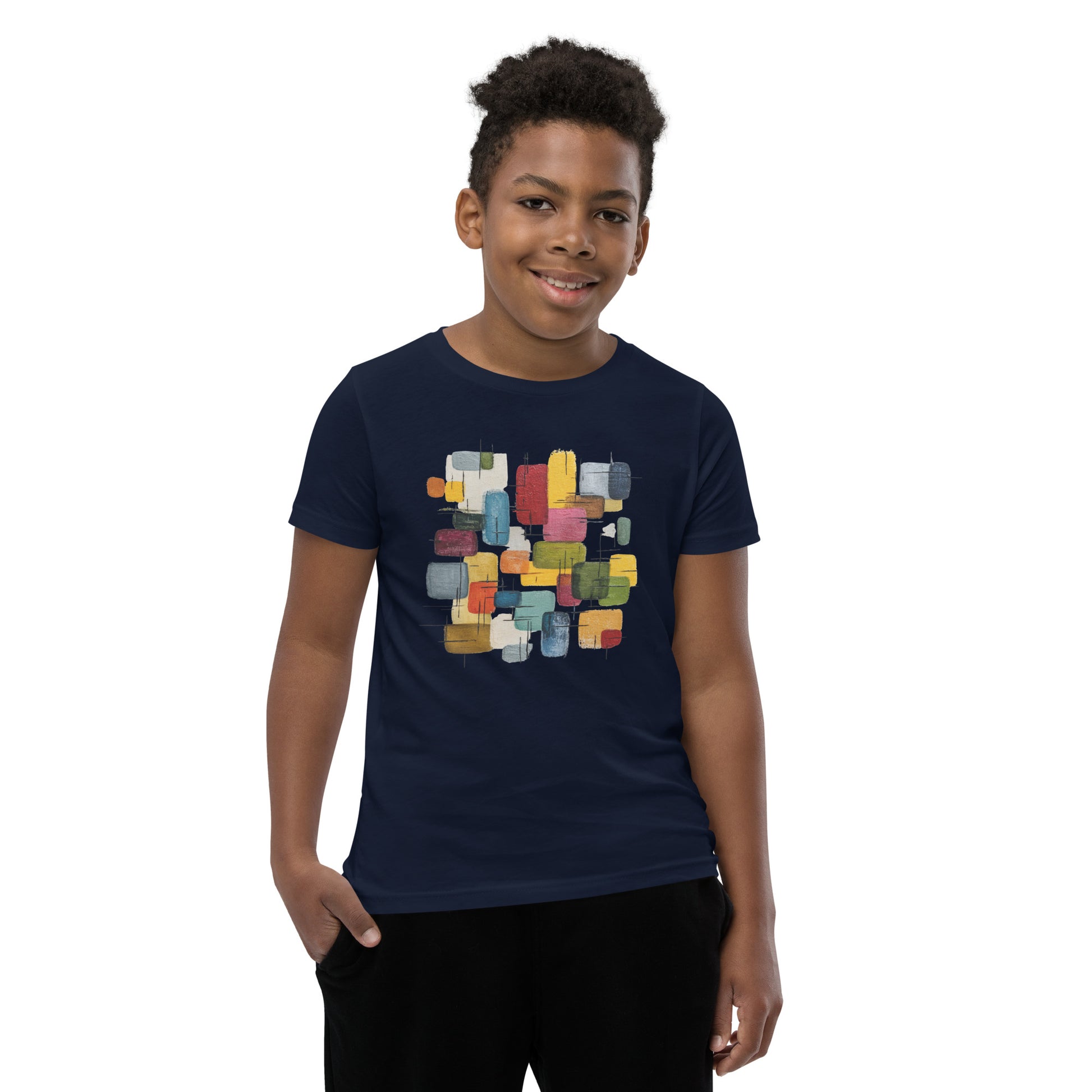 Product mockup. A young man wearing a navy blue, short-sleeve t-shirt with a large, colorful abstract design on the front. The design features overlapping rounded rectangles in red, yellow, teal, blue, green, and orange, with fine black sketch lines, creating a playful and modern look. She is also wearing black leggings.