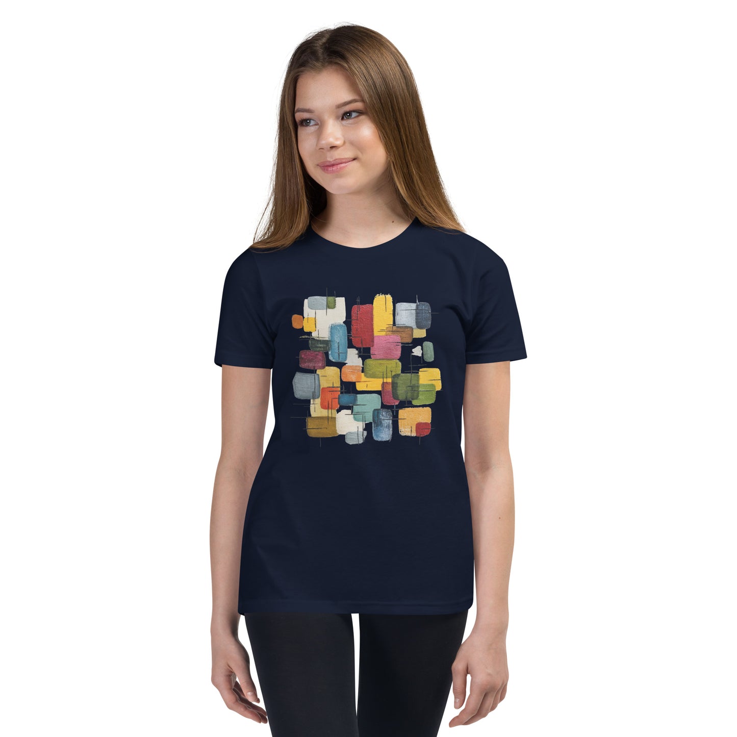 Product mockup. A young woman wearing a navy blue, short-sleeve t-shirt with a large, colorful abstract design on the front. The design features overlapping rounded rectangles in red, yellow, teal, blue, green, and orange, with fine black sketch lines, creating a playful and modern look. She is also wearing black leggings.