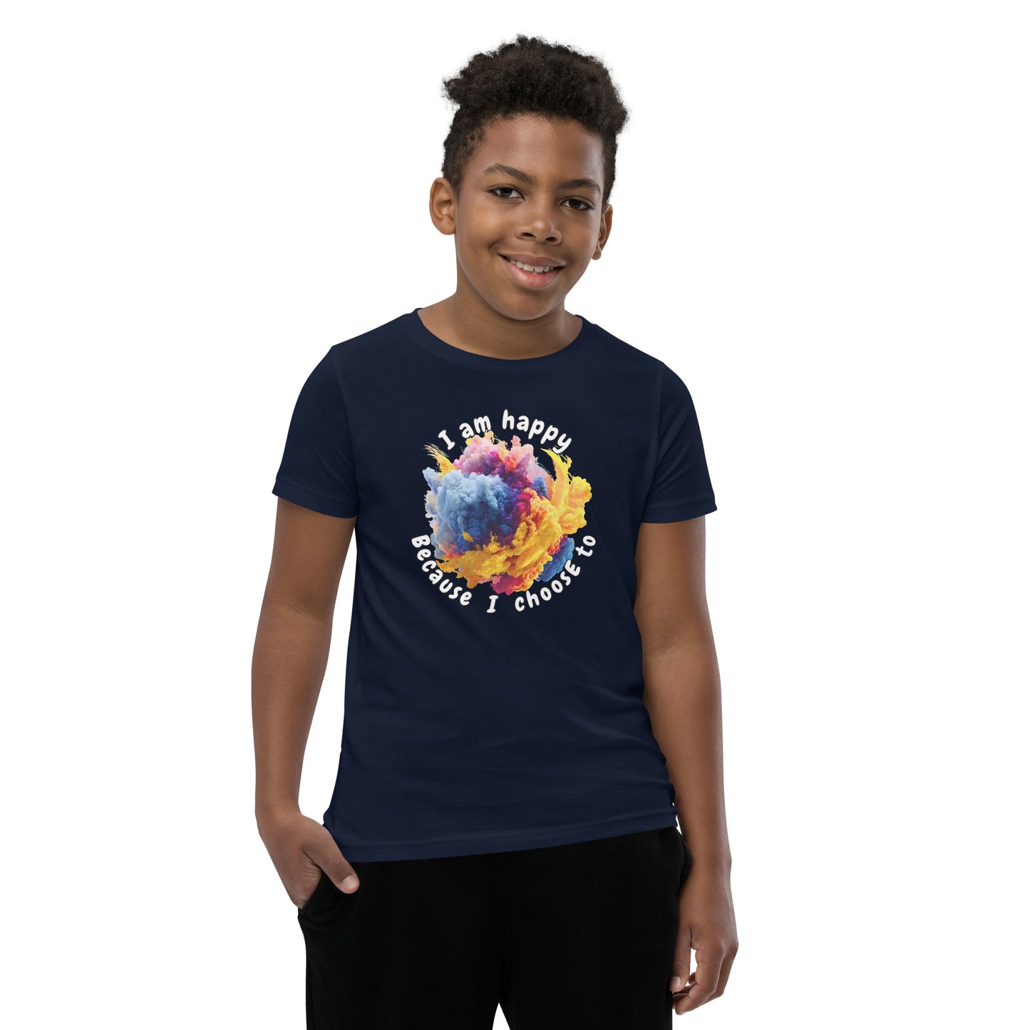 Product mockup. A smiling young boy wearing a navy blue t-shirt with a colorful, cloud-like burst of blue, pink, purple, and yellow at the chest. Above and below the design, curved white text reads, 'I am happy Because I choose to,' in a playful, rounded font.
