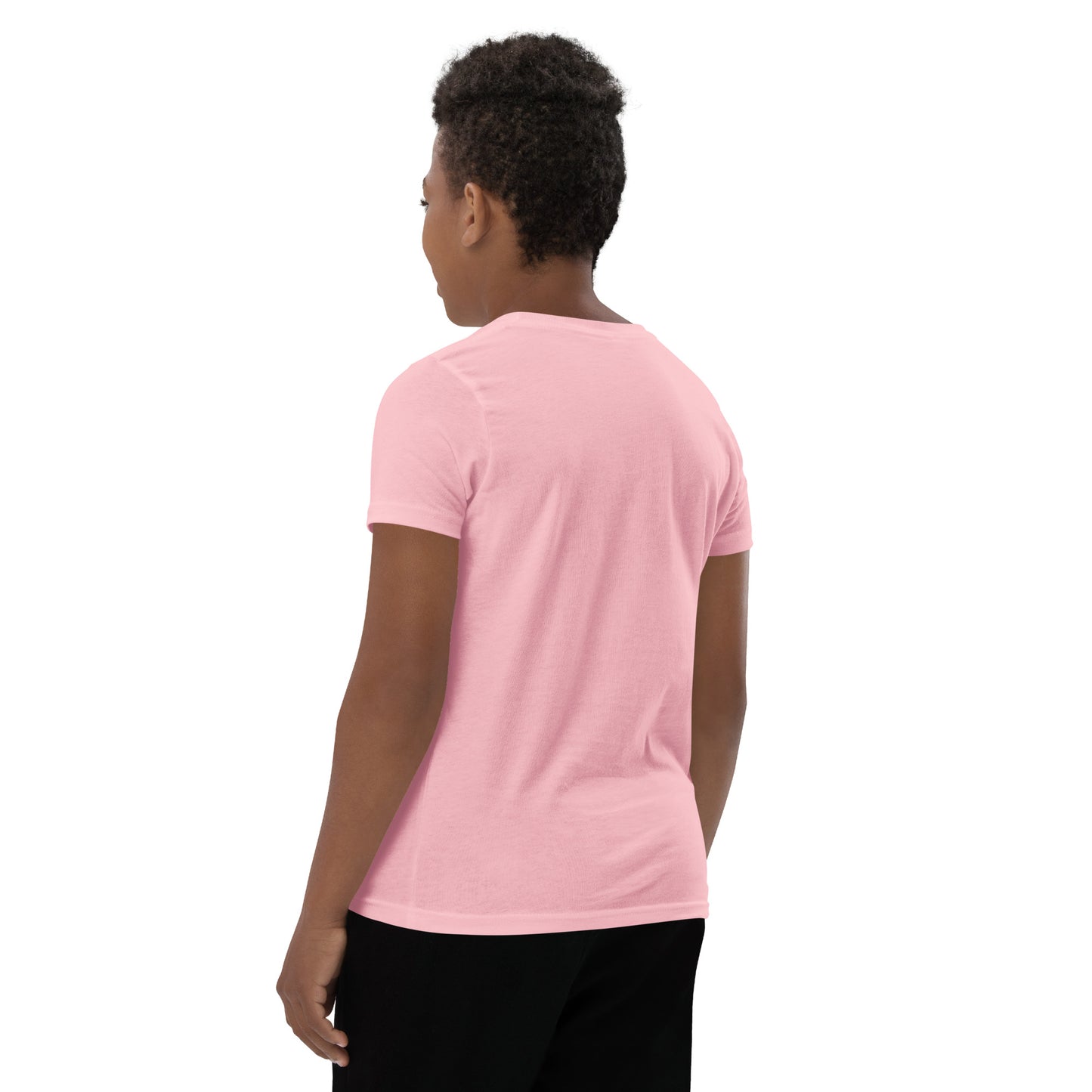 Product mockup. A boy shown from behind wearing a plain light pink, short-sleeve t-shirt and black pants. His curly hair is closely cropped, and the back of the shirt is blank with no visible design or graphics.
