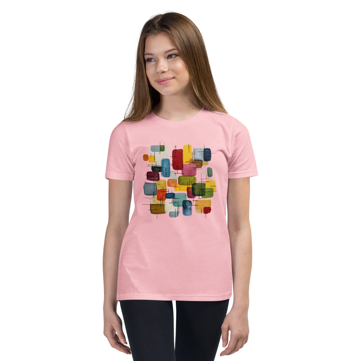 Product mockup. A young woman wearing a light pink, short-sleeve t-shirt with a large, colorful abstract design on the front. The design features overlapping rounded rectangles in red, yellow, teal, blue, green, and orange, with fine black sketch lines, creating a playful and modern look. She is also wearing black leggings.