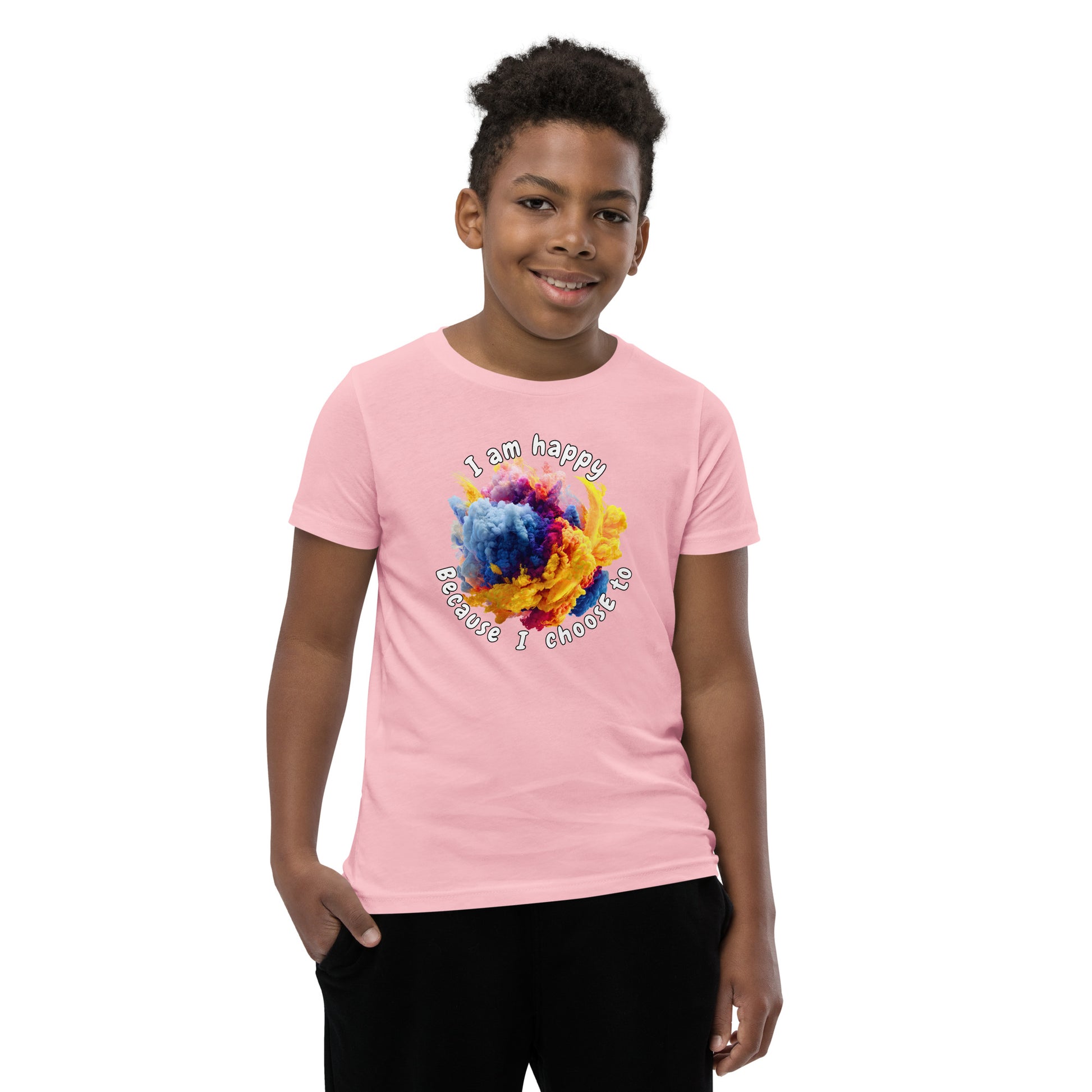 Product mockup. A smiling young boy wearing a light blue t-shirt with a colorful, cloud-like burst of blue, pink, purple, and yellow at the chest. Above and below the design, curved white text reads, 'I am happy Because I choose to,' in a playful, rounded font.
