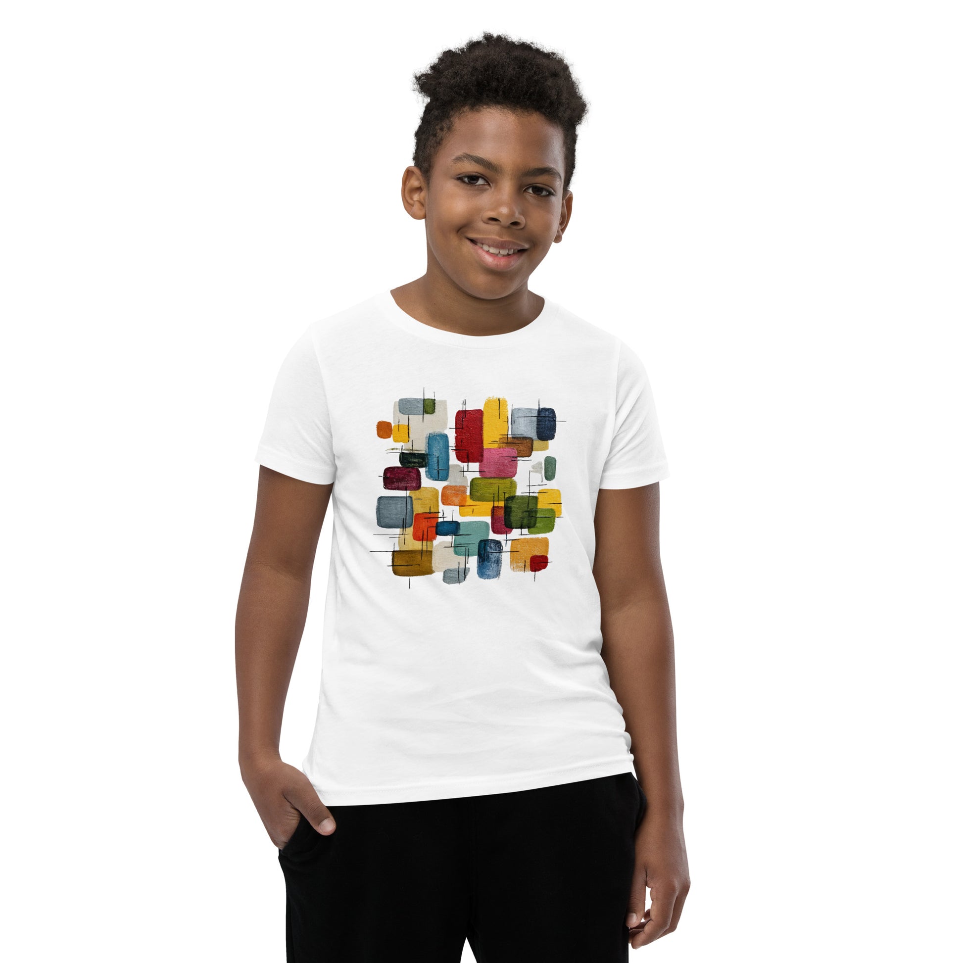 Product mockup. A young man wearing a white, short-sleeve t-shirt with a large, colorful abstract design on the front. The design features overlapping rounded rectangles in red, yellow, teal, blue, green, and orange, with fine black sketch lines, creating a playful and modern look. She is also wearing black leggings.
