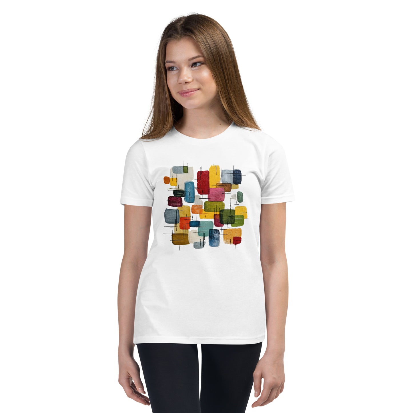 Product mockup. A young woman wearing a white, short-sleeve t-shirt with a large, colorful abstract design on the front. The design features overlapping rounded rectangles in red, yellow, teal, blue, green, and orange, with fine black sketch lines, creating a playful and modern look. She is also wearing black leggings.