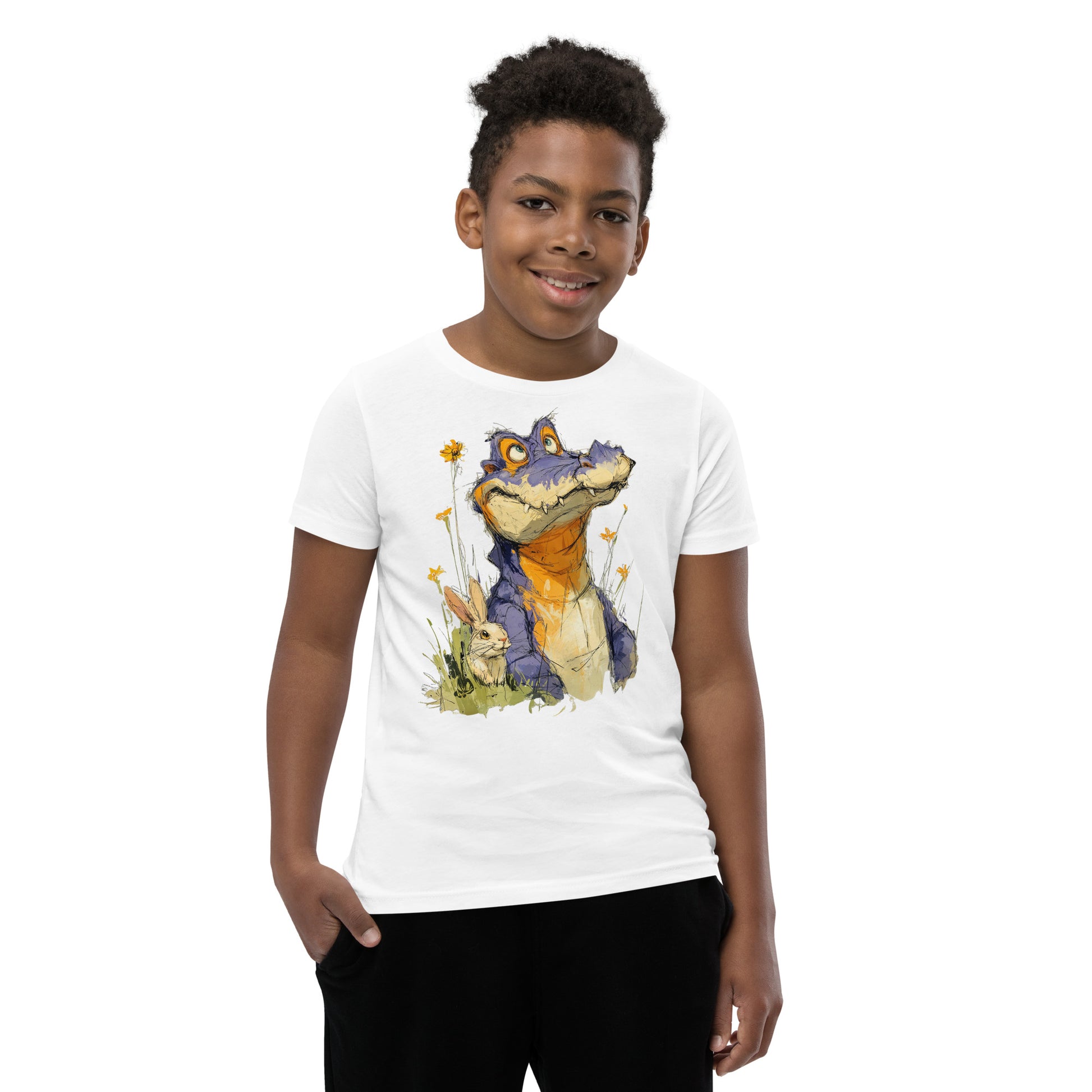 Product mockup.  A smiling child wearing a white t‑shirt featuring a whimsical sketch of a purple alligator with orange accents sitting in tall grass beside a white rabbit and yellow wildflowers, set against a clean studio background.